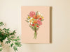 two hands holding 8x10 inch canvas with spring flowers pastel easter art against a white living room wall with house plant in the foreground