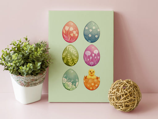 8x10 canvas with colorful easter artwork of rows of eggs and a baby chick in front of a pink wall next to a potted plant and a wooden ball decoration