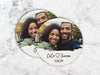 Two coasters sit on a marble surface. Coasters shown are customizable. Coasters are designed with custom photo, text, and brushed elements. Coaster text reads CeCe &lt;3 Simon, 3/18/25