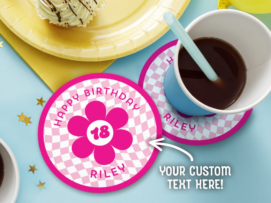 One coaster has a drink on it and an empty coaster sits beside it on a decorated table. Coasters are designed with hot and light pink ink. Coaster text reads Happy Birthday Riley with the number 18 in the center of a pink flower.