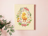 8x10 inch canvas with spring easter chick pastel easter art on a pink living room wall next to a house plant