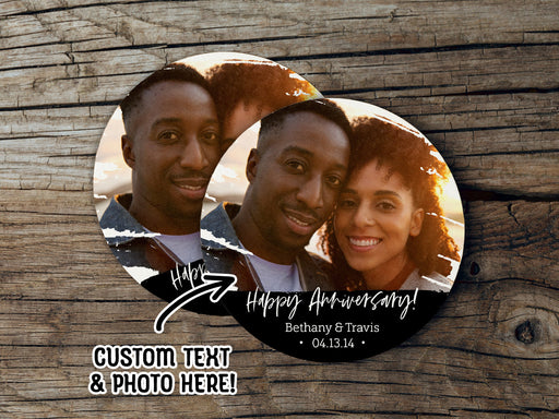 Two coasters sit on a wooden surface. Coasters shown are customizable. Coasters are designed with custom photo, text, and brushed elements. Coaster text reads Happy Anniversary! Bethany & Travis, 04.13.14