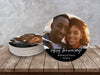 A stack of coasters by a single coaster on a wooden table with a gray wall behind. Coasters shown are customizable. Coasters are designed with custom photo, text, and brushed elements. Coaster text reads Happy Anniversary! Bethany & Travis, 04.13.14