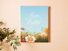 8x10 canvas of happy easter artwork of a spring meadow on an orange living room wall next to a house plant