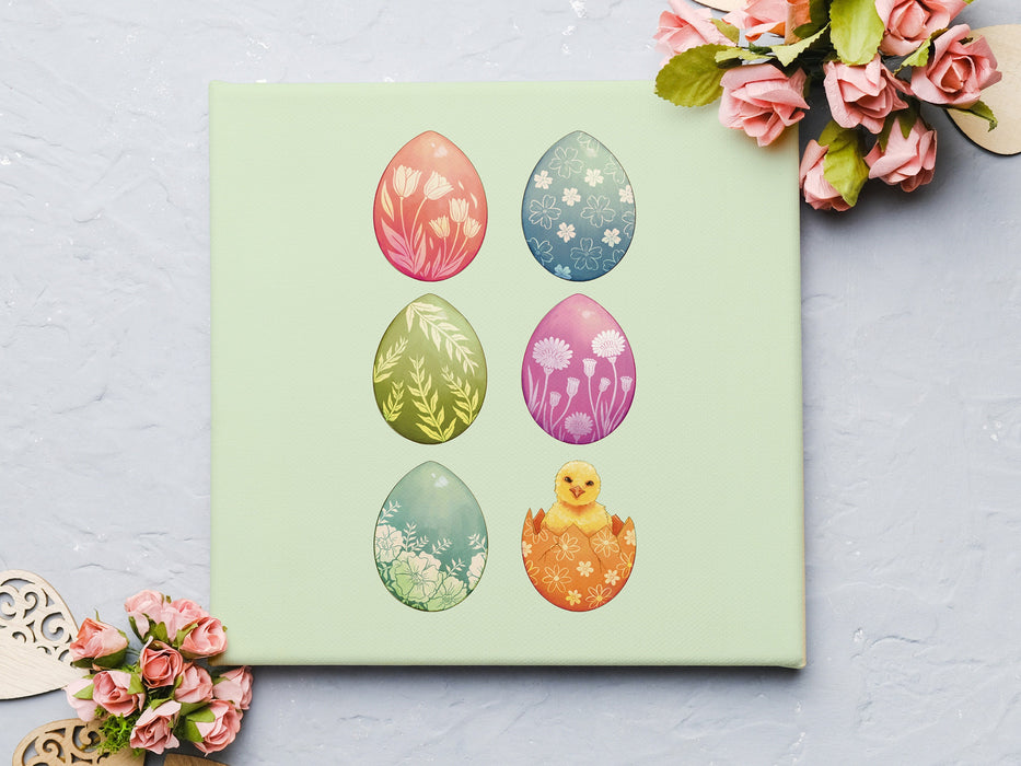 12x12 canvas with colorful easter artwork of rows of eggs and a baby chick on a light blue surface surrounded by pink paper roses and wooden heart decorations