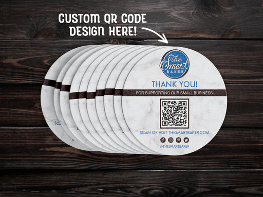 text says Custom QR code design here
image shows stack of custom QR code round coaster spread out on a dark wooden table