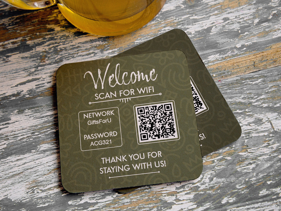 two custom square QR code coasters that offer free wifi and the wifi password on a grey wood table with a glass bottle of beer