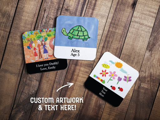 three square paper coasters with kids artwork and custom text printed on the coasters on a wooden table
text says Custom Artwork & Text Here!