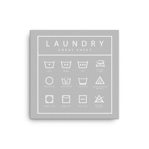 Canvas print with Laundry Cheet Sheet design. Design features a list of laundry icons. List has icons and text for cold, warm, hot, do not iron, dry clean, hand wash, delicate, non-chlorine bleach, tumble dry, hang dry, dry flat, do not bleach. Print is gray with details printed in white.